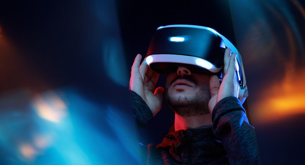 Model young man with beard in glasses of virtual reality. Augmen