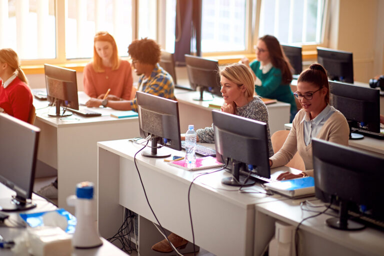 IT workshop at university. Group of Students on class with compu